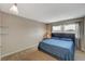 Spacious primary bedroom with king-size bed and large window at 3933 Manford Cir, Las Vegas, NV 89104