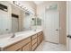 Double vanity bathroom with a large mirror and tile floors at 10305 Snyder Ave, Las Vegas, NV 89134