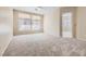 Bright and airy living room with carpeted floor and large windows at 10305 Snyder Ave, Las Vegas, NV 89134