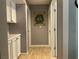 Clean hallway with light colored wood floors and white cabinets at 3037 Isaac River Dr, Las Vegas, NV 89134