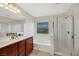 Main bathroom with double vanity, soaking tub and shower at 6476 Chebec St, North Las Vegas, NV 89084