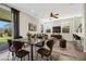 Bright dining area features a metal table with brown leather chairs at 6476 Chebec St, North Las Vegas, NV 89084