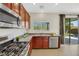 Modern kitchen with stainless steel appliances and wooden cabinetry at 6476 Chebec St, North Las Vegas, NV 89084