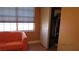 Bedroom with orange couch, closet, and window at 8637 Stone Harbor Ave, Las Vegas, NV 89145