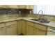 L-shaped kitchen with granite countertops and modern appliances at 8637 Stone Harbor Ave, Las Vegas, NV 89145