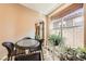 Small breakfast nook with wicker chairs and a glass-top table at 819 Cardamom Ct, Henderson, NV 89015