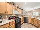 Kitchen with oak cabinets, stainless steel appliances, and granite countertops at 819 Cardamom Ct, Henderson, NV 89015