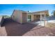 Landscaped backyard with gravel and covered patio at 5435 Mountain Vista St, Las Vegas, NV 89120