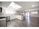 Open kitchen with white cabinets, stainless steel appliances, and views to living room at 5435 Mountain Vista St, Las Vegas, NV 89120