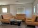 Comfortable living room with light leather sofas and a coffee table at 3605 Perching Bird Ln, North Las Vegas, NV 89084