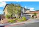 Two-story house with beige exterior, tile roof and three-car garage at 1040 Bonny Lake Ct, Henderson, NV 89015