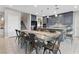 Kitchen and dining area with a large farmhouse table and gray cabinetry at 14 Parco Fiore Ct, Henderson, NV 89011