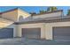 Exterior view of attached garages with gray doors at 5250 S Rainbow Blvd # 1027, Las Vegas, NV 89118