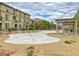 Community courtyard with a sandy play area and pergola at 4591 Woolcomber St, Las Vegas, NV 89115