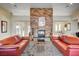 Living room with a large stone fireplace and comfortable seating at 4591 Woolcomber St, Las Vegas, NV 89115