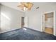 Bedroom with ceiling fan, mirrored closet, and access to bathroom at 700 Carnegie St # 1512, Henderson, NV 89052