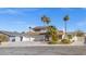 Two-story house with solar panels, three-car garage, and palm trees at 4574 Casa Mia Cir, Las Vegas, NV 89121