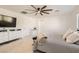 Spacious bedroom with a striped comforter and ceiling fan at 7470 Pepperbox Ave, Las Vegas, NV 89179