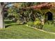 Spanish-style home with a red tile roof and lush landscaping at 14 Pheasant Ridge Dr, Henderson, NV 89014