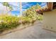 Spacious tiled patio with lush landscaping, offering outdoor living space at 14 Pheasant Ridge Dr, Henderson, NV 89014