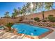 Sparkling blue pool with stone coping and landscaping at 1675 Silver Rain Ave, Las Vegas, NV 89123