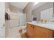 Main bathroom with tub, shower, and wood cabinets at 2506 Starlight Valley St, Henderson, NV 89044