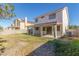 Two-story home exterior with covered patio and grassy backyard area at 2751 Desert Stream Ct, Las Vegas, NV 89156