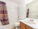 Bathroom featuring a bathtub, toilet, and vanity with oak wood cabinet at 2751 Desert Stream Ct, Las Vegas, NV 89156