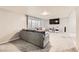 Living room with grey sectional and large TV at 3187 Silver Saddle St, Las Vegas, NV 89169