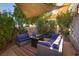 Relaxing backyard patio with shaded seating area and lush landscaping at 3368 Epson St, Las Vegas, NV 89129