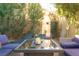 Inviting backyard with a patio table, lounge chairs, and desert landscaping at 3368 Epson St, Las Vegas, NV 89129