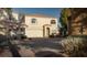 Two-story house with attached garage and well-maintained landscaping at 3368 Epson St, Las Vegas, NV 89129