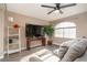 Relaxing living room featuring a large TV, comfortable seating, and a ceiling fan at 3368 Epson St, Las Vegas, NV 89129