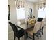 Elegant dining area with dark wood table and neutral chairs at 724 Last Dance Pl, Henderson, NV 89011