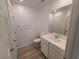 Clean bathroom with toilet, sink, and vanity with a mirror at 7332 N Decatur Blvd # 2, North Las Vegas, NV 89084