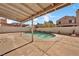 Relaxing kidney-shaped pool with patio and covered structure at 5849 Killala Ct, Las Vegas, NV 89110