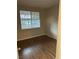 Simple bedroom with wood-look flooring and a window at 1404 Seward St # 104, Las Vegas, NV 89128