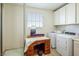 Laundry room with washer, dryer, and a wooden desk at 1164 Sparta Crest Street, Henderson, NV 89052