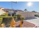 Tan two-story stucco home with tile roof, attached garage, and landscaping at 3356 Racquet St, Las Vegas, NV 89121