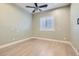 Well-lit bedroom with wood-look floors and window shutters at 5790 Douglas Everett St, Las Vegas, NV 89120