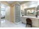 Elegant bathroom with a large vanity, soaking tub, and glass block accents at 8207 Crow Valley Ln, Las Vegas, NV 89113