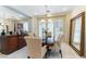 Well-lit dining area with a dark wood table and light-colored chairs at 8207 Crow Valley Ln, Las Vegas, NV 89113