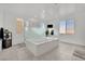 Modern bathroom with a large soaking tub and glass shower at 2188 Radiant Horizon Ave, Henderson, NV 89052