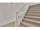 Image of a carpeted staircase with white railings at 5413 Carnation Meadow St, Las Vegas, NV 89130