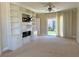 Living room with white built-in fireplace, sliding glass door to backyard, and carpet at 2900 Foxtail Creek Ave, Henderson, NV 89052