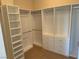 Spacious walk-in closet with built-in shelving and drawers at 2900 Foxtail Creek Ave, Henderson, NV 89052