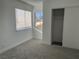 Bedroom with gray carpeting, window, and built-in closet at 5814 Goodsprings Ct, Las Vegas, NV 89110