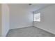 Spacious bedroom with gray carpeting and a window with blinds at 5814 Goodsprings Ct, Las Vegas, NV 89110