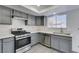 Updated kitchen featuring gray cabinets and stainless steel appliances at 5814 Goodsprings Ct, Las Vegas, NV 89110