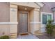 Inviting front entrance with gray door and house number 101 at 8824 Traveling Breeze Ave # 101, Las Vegas, NV 89178